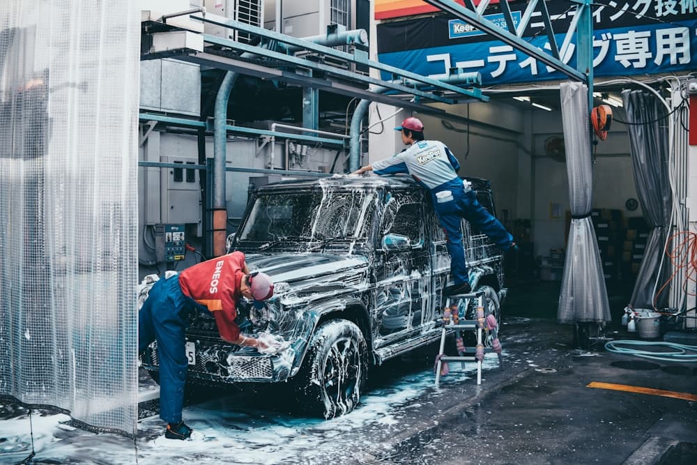 Two people washing a car together