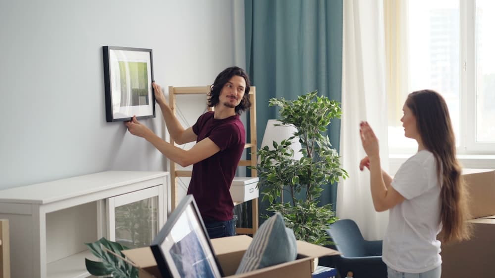 Two people unpacking moving boxes in a new home